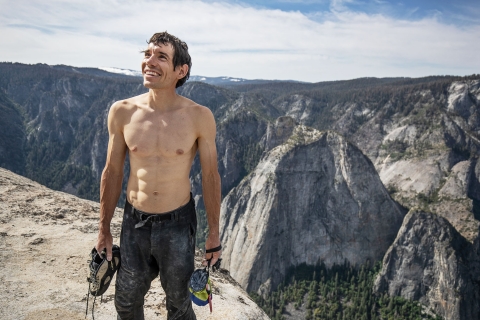 Alex Honnold holds all of his climbing gear atop the summit of El Capitan. He just became the first person to climb El Capitan without a rope. (National Geographic/Jimmy Chin)